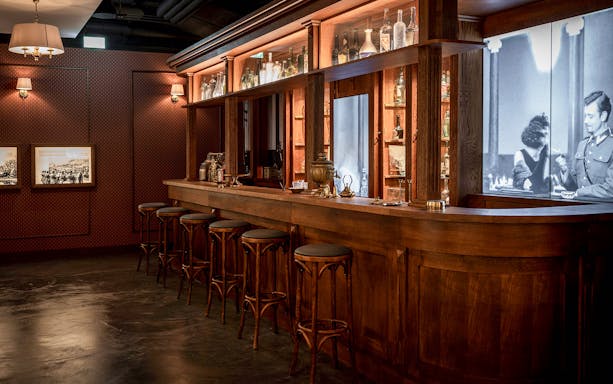 Krakow Vodka Factory Museum bar with vintage decor and historical photographs.