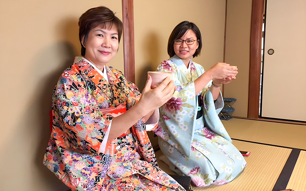 Women in kimonos participating in a tea ceremony in Kyoto.