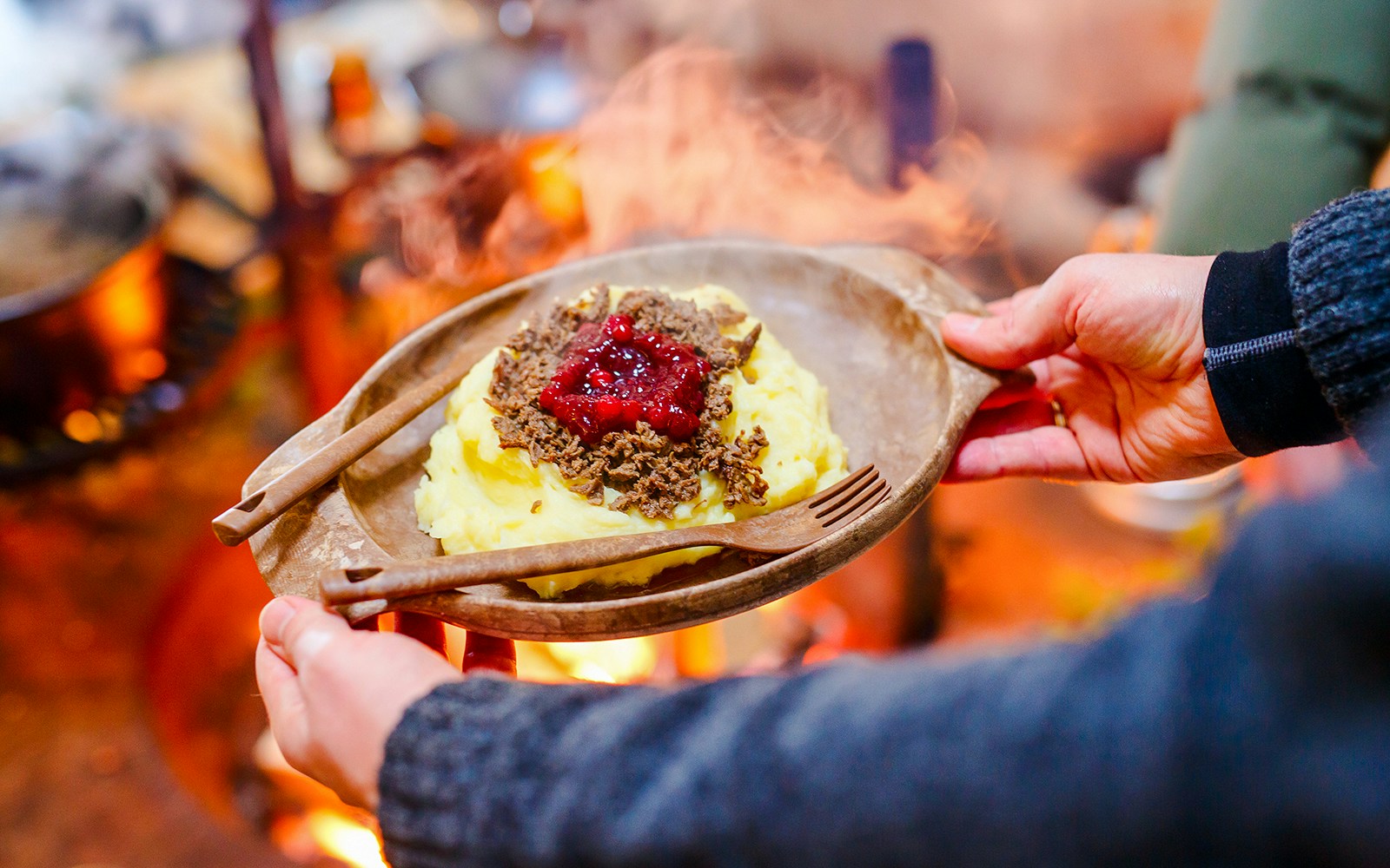 Reindeer meat with mashed potatoes and lingonberry sauce, traditional Finnish dish.