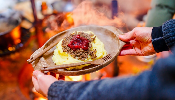 Reindeer meat with mashed potatoes and lingonberry sauce, traditional Finnish dish.