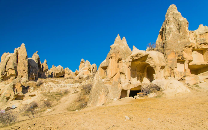 Rock formations in Paşabağ Valley, Cappadocia, with ancient cave dwellings.