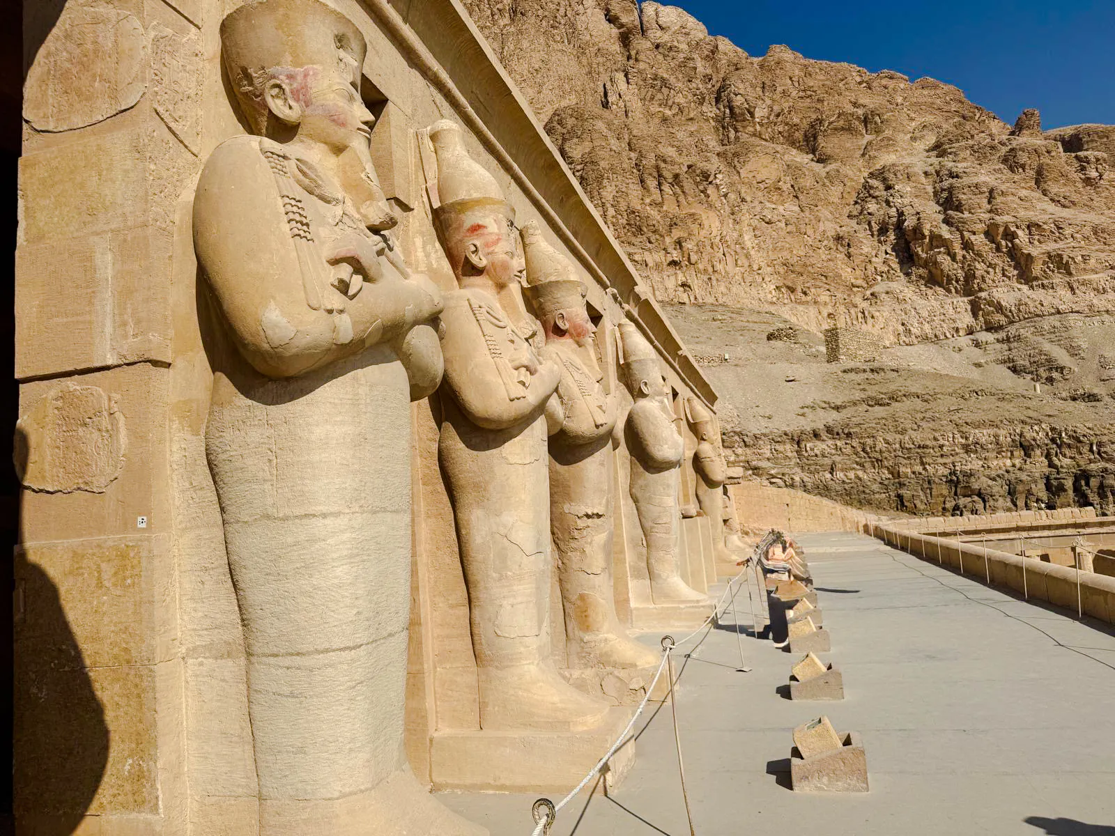 Ancient statues at Hatshepsut Temple, Luxor, part of the Nile Serenade tour from Aswan.