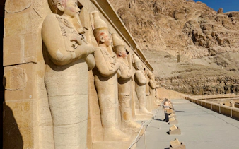 Ancient statues at Hatshepsut Temple, Luxor, part of the Nile Serenade tour from Aswan.