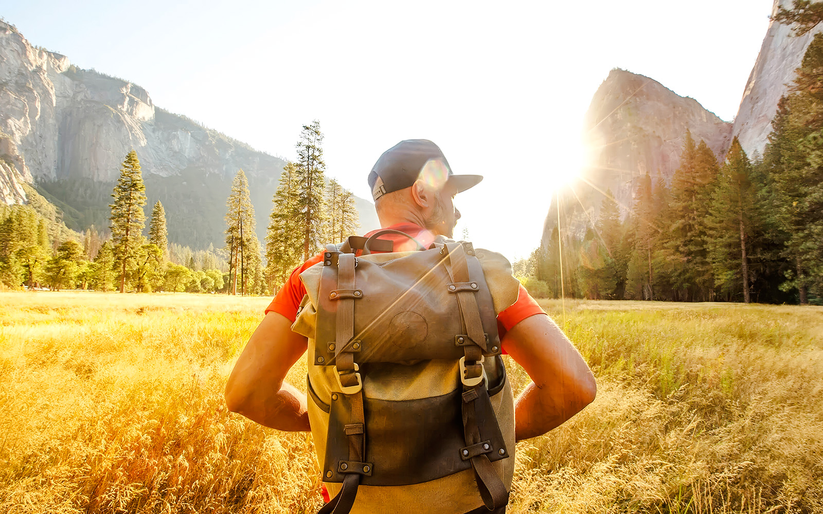 Hiker with backpack in Yosemite Valley during day tour from San Francisco.