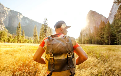 Hiker with backpack in Yosemite Valley during day tour from San Francisco.