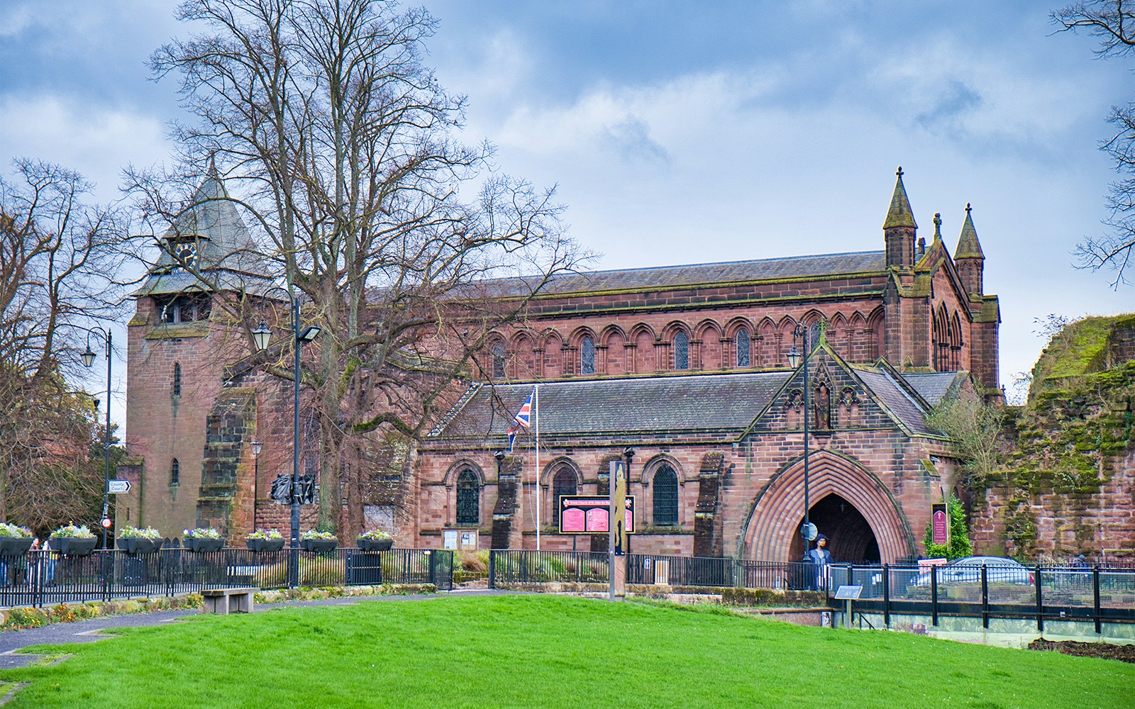 Chester St John’s Church in England with historic architecture and surrounding greenery.