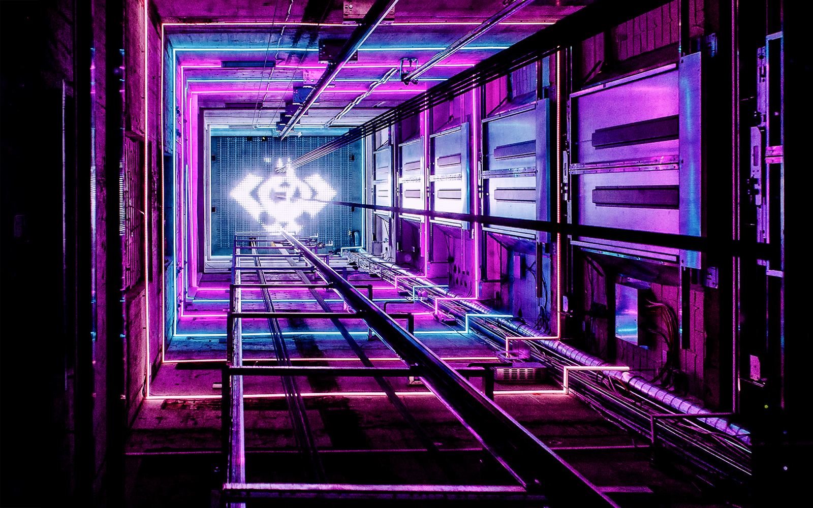 ADAM Lookout elevator shaft with vibrant neon lights in Amsterdam.
