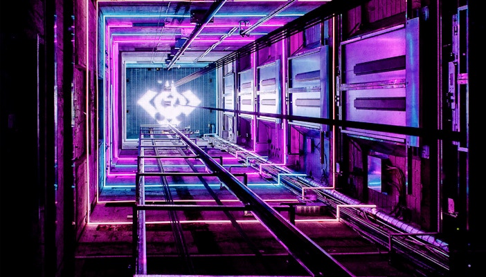 ADAM Lookout elevator shaft with vibrant neon lights in Amsterdam.