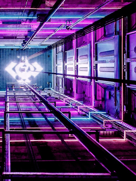 ADAM Lookout elevator shaft with vibrant neon lights in Amsterdam.