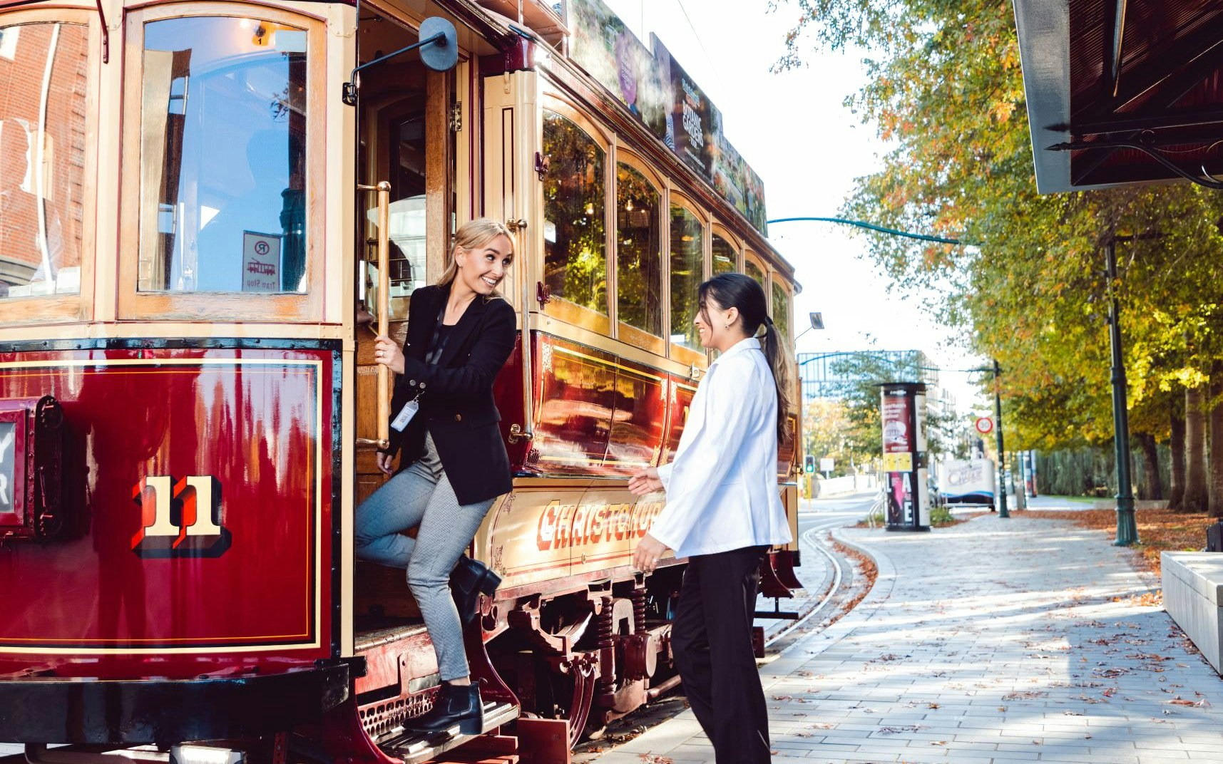 Women boarding a vintage tram in Christchurch.