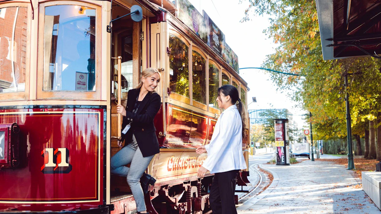 Women boarding a vintage tram in Christchurch.