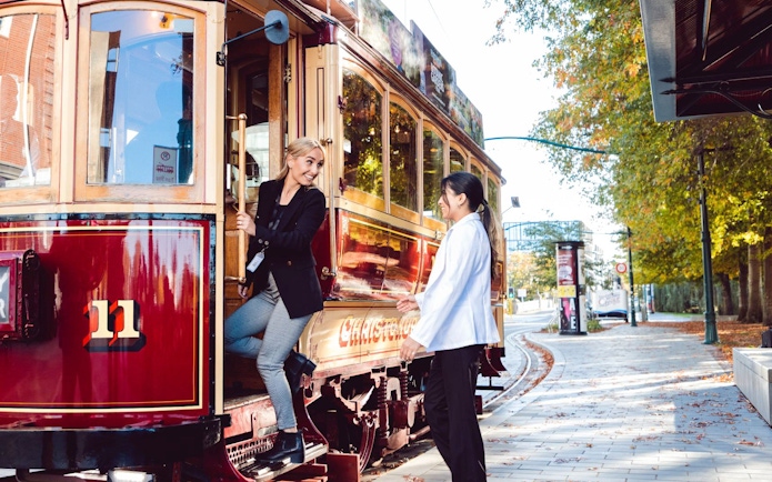 Women boarding a vintage tram in Christchurch.
