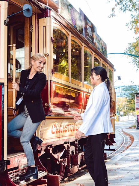 Women boarding a vintage tram in Christchurch.