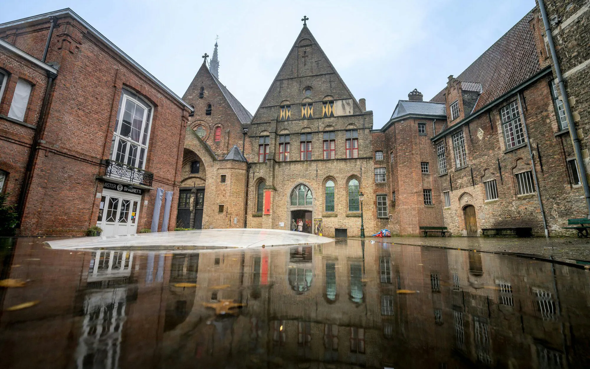 Museum Sint-Janshospitaal courtyard with historic brick architecture in Bruges, Belgium.