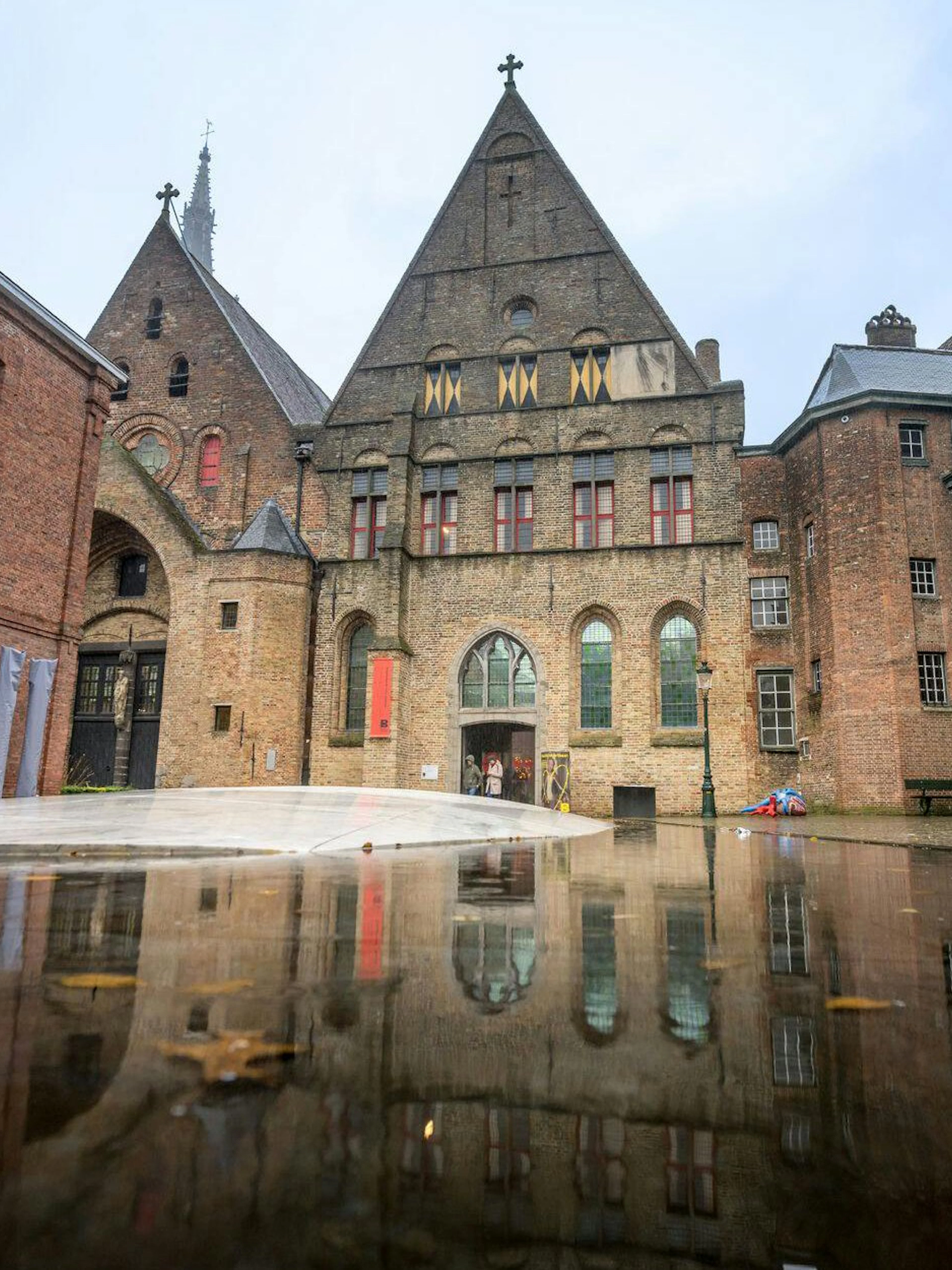 Museum Sint-Janshospitaal courtyard with historic brick architecture in Bruges, Belgium.