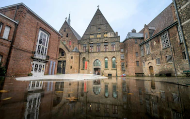 Museum Sint-Janshospitaal courtyard with historic brick architecture in Bruges, Belgium.