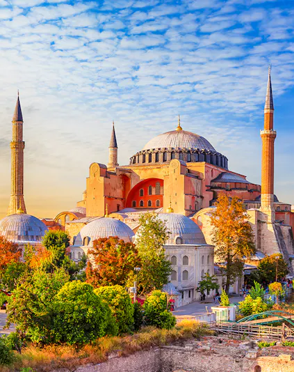 Hagia Sophia in Istanbul with minarets under a blue sky.