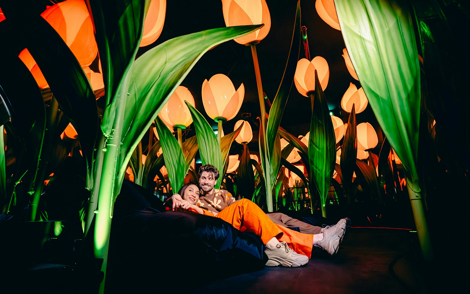 Guests relaxing among giant tulip sculptures on the Highlights of Holland tour.