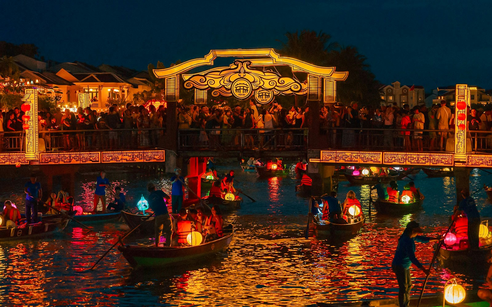 Hoi An Night Market with lantern-lit boats on the Thu Bon River in Hoi An Ancient Town.