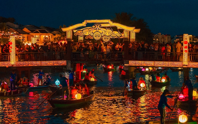Hoi An Night Market with lantern-lit boats on the Thu Bon River in Hoi An Ancient Town.