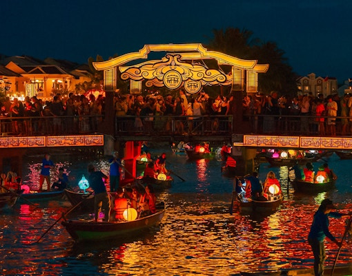 Hoi An Night Market with lantern-lit boats on the Thu Bon River in Hoi An Ancient Town.