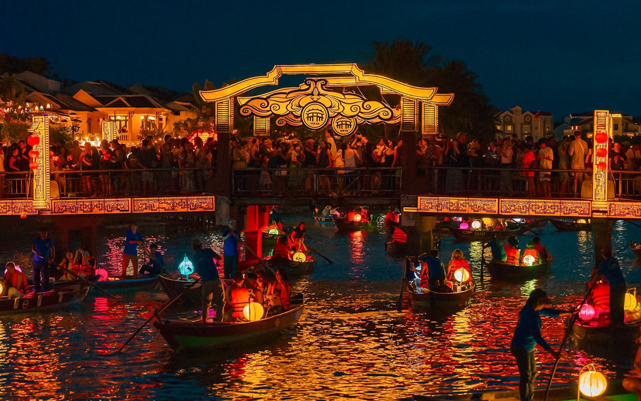 Hoi An Night Market with lantern-lit boats on the Thu Bon River in Hoi An Ancient Town.
