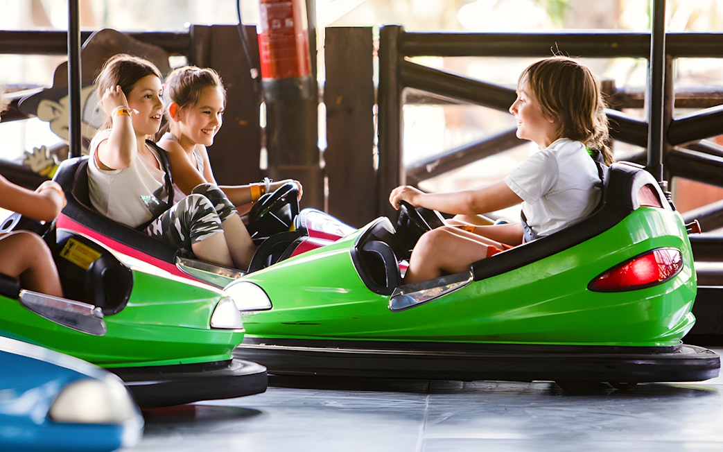 Children enjoying Rugrats Bumper Cars at Parque de Atracciones de Madrid.