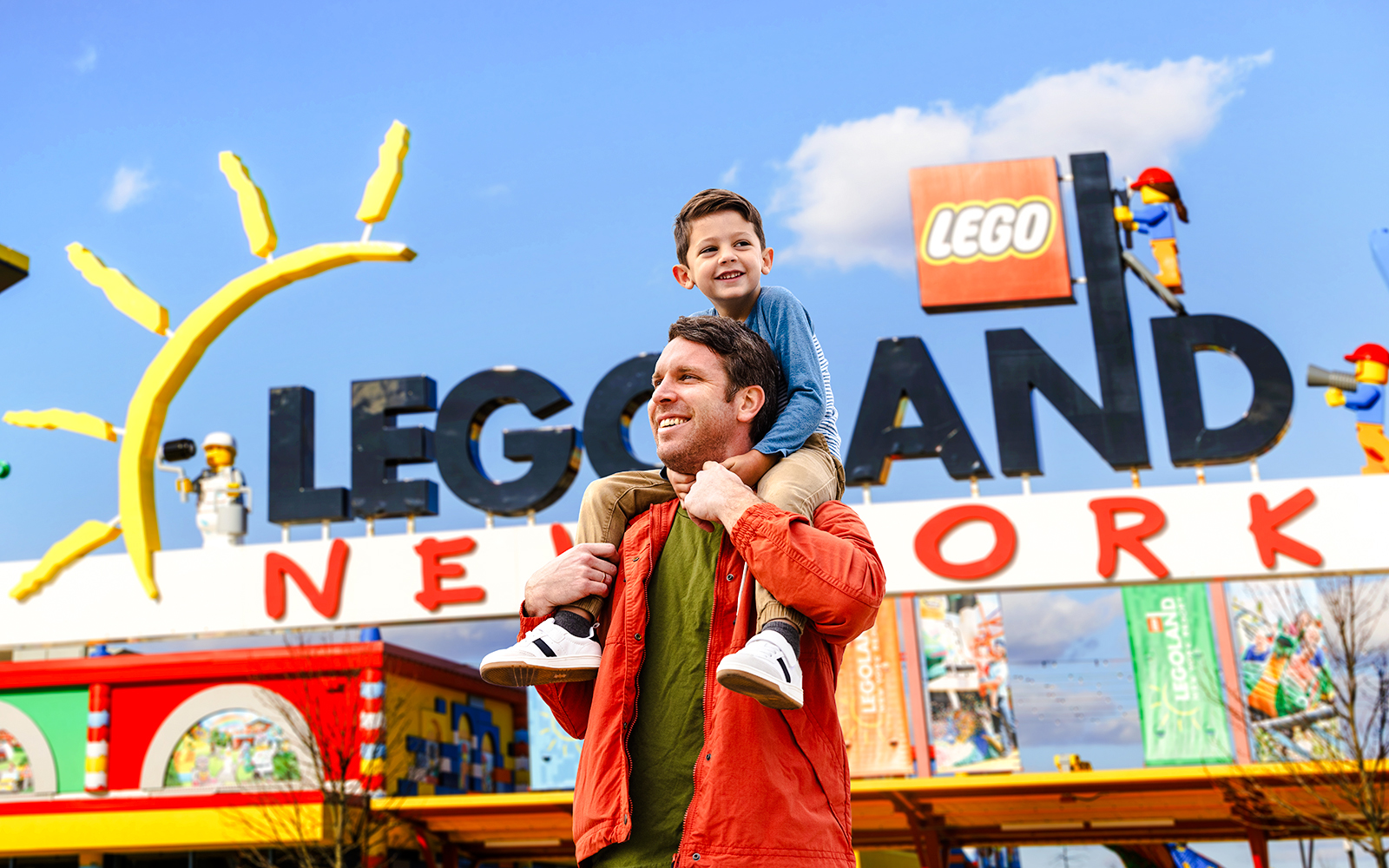 Father and son enjoying their visit at Legoland New York entrance.