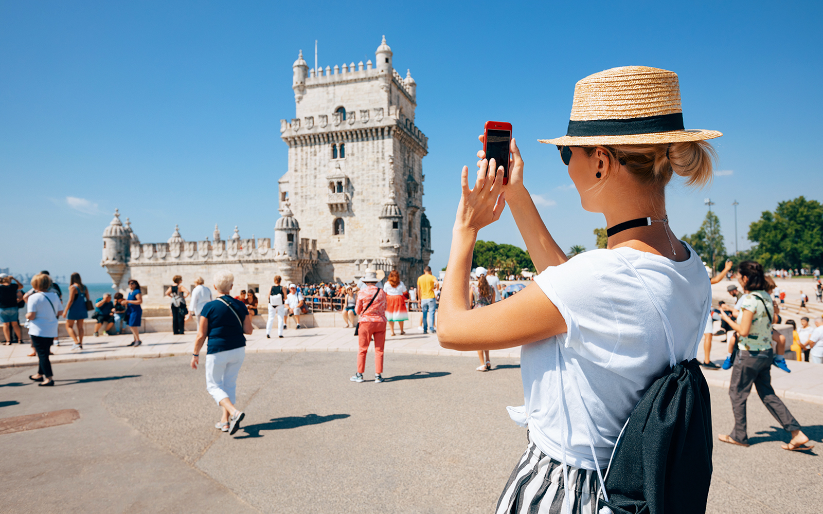 Woman taking a picture of Belem Tower