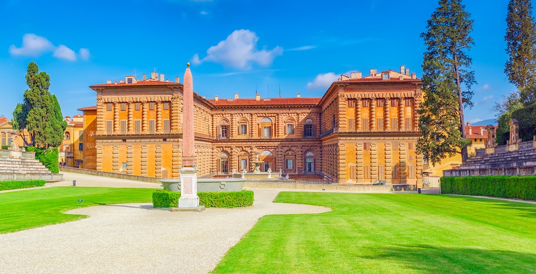 Pitti Palace facade with obelisk and gardens in Florence, Italy.
