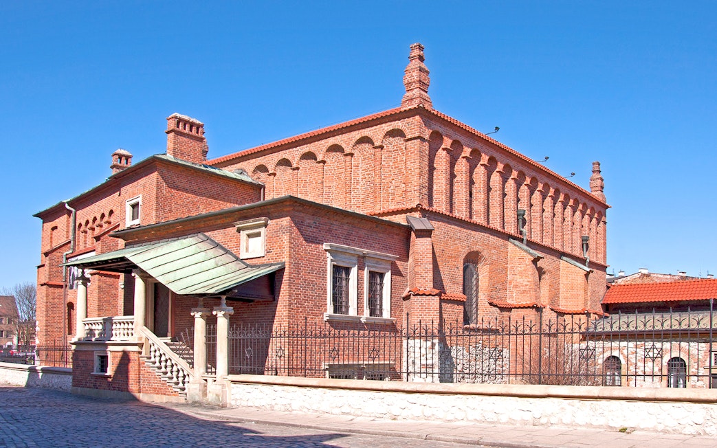 Old Synagogue in Jewish Ghetto, Krakow, with red brick architecture and arched windows.