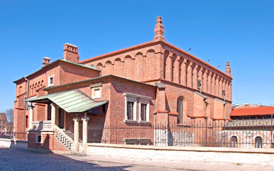 Old Synagogue in Jewish Ghetto, Krakow, with red brick architecture and arched windows.