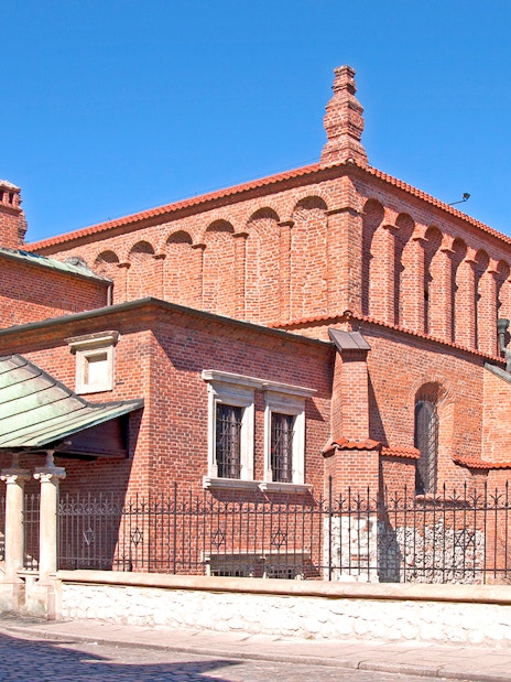 Old Synagogue in Jewish Ghetto, Krakow, with red brick architecture and arched windows.