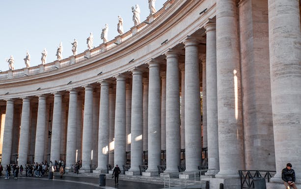 Colonnade of St. Peter's Square with statues, Rome guided minivan tour.