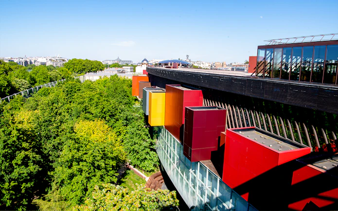 Musee du Quai Branly exterior with colorful facade and lush greenery in Paris.