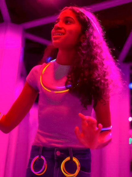 Kids exploring Mirror Maze at American Dream, surrounded by glowing lights.