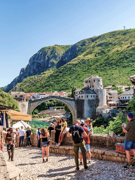 Old Town of Mostar with Stari Most bridge and tourists, Bosnia-Herzegovina.