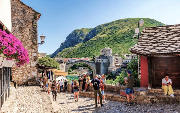 Old Town of Mostar with Stari Most bridge and tourists, Bosnia-Herzegovina.