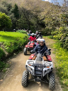 ATV riders exploring a forest trail during Alcantara Gorge tour.