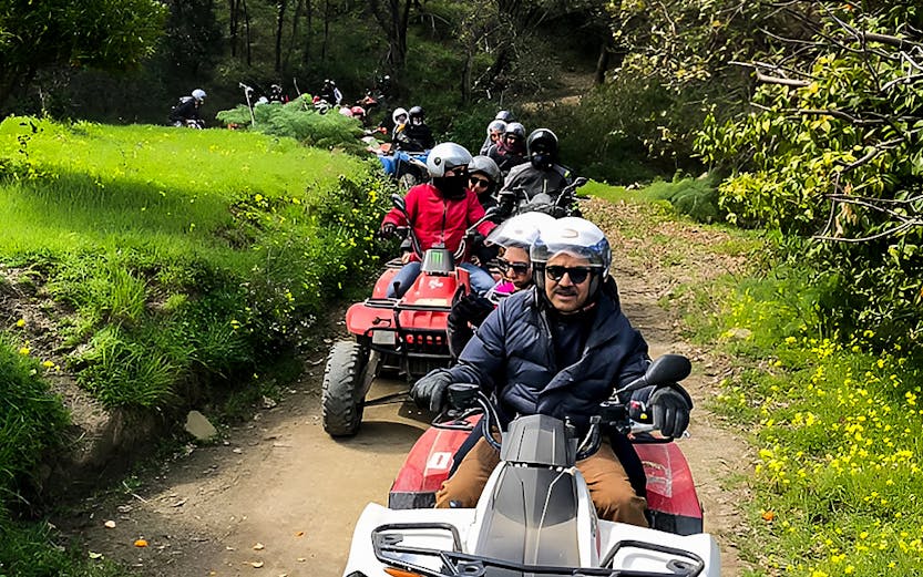 ATV riders exploring a forest trail during Alcantara Gorge tour.