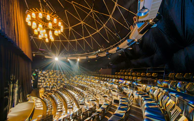 Teh Dar Vietnamese Bamboo Circus seating under iconic dome with stage lighting.