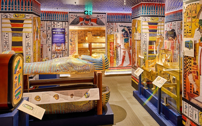 Sarcophagus and Egyptian artifacts displayed at the Tomb of the Pharaoh exhibit.