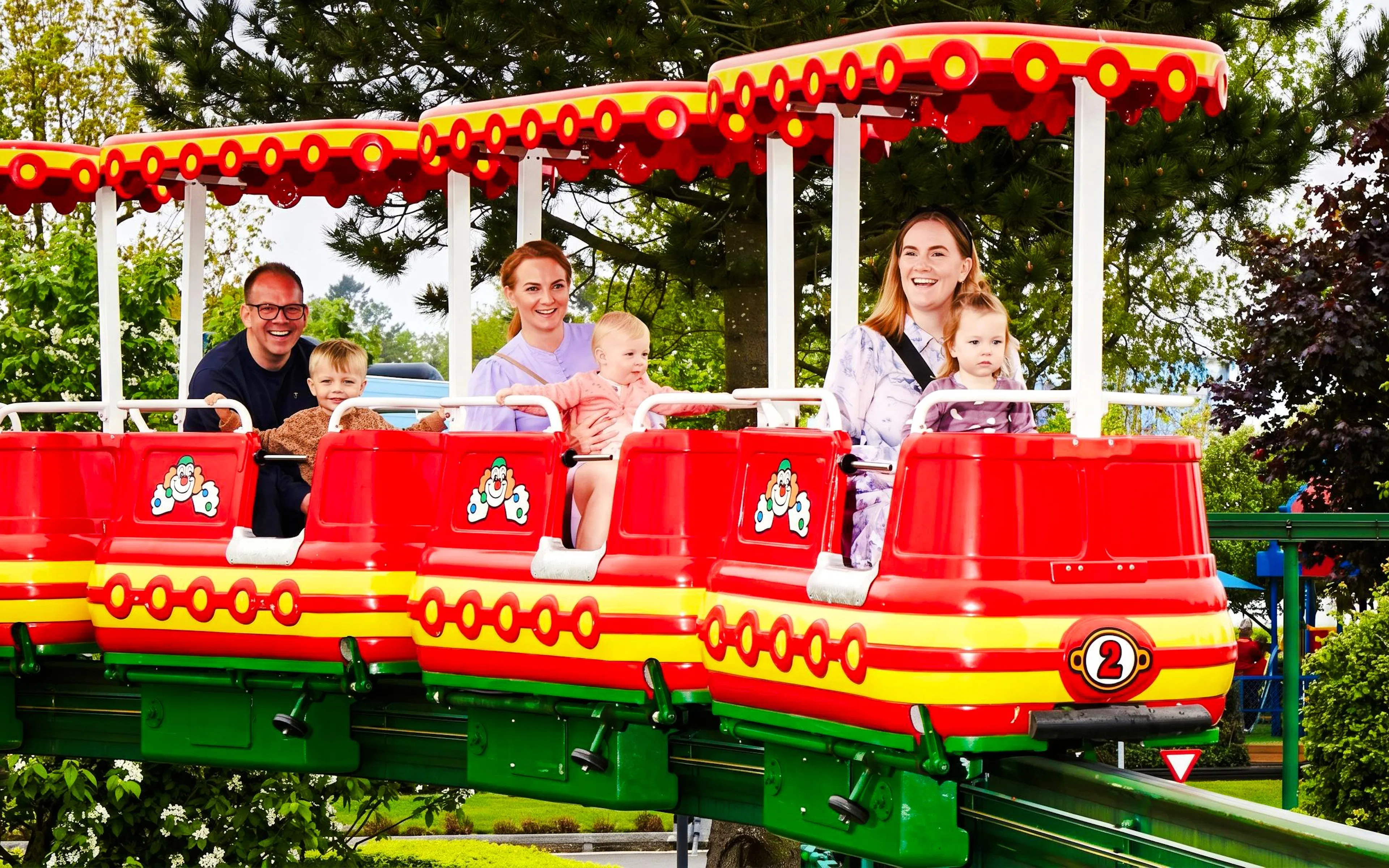 Families enjoying a ride on the LEGO Train at Legoland Billund.