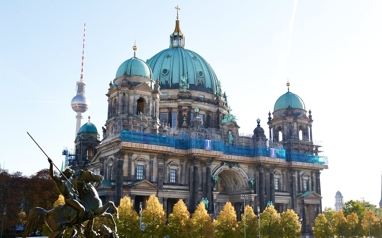 Berlin Cathedral with TV Tower in background on a sunny day.