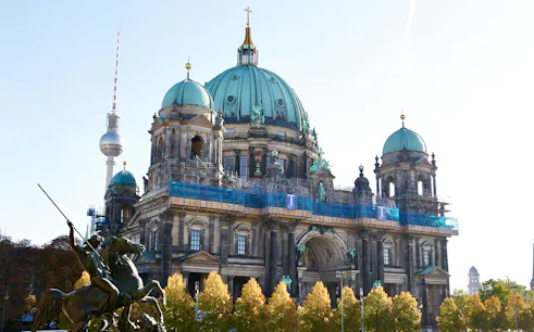 Berlin Cathedral with TV Tower in background on a sunny day.