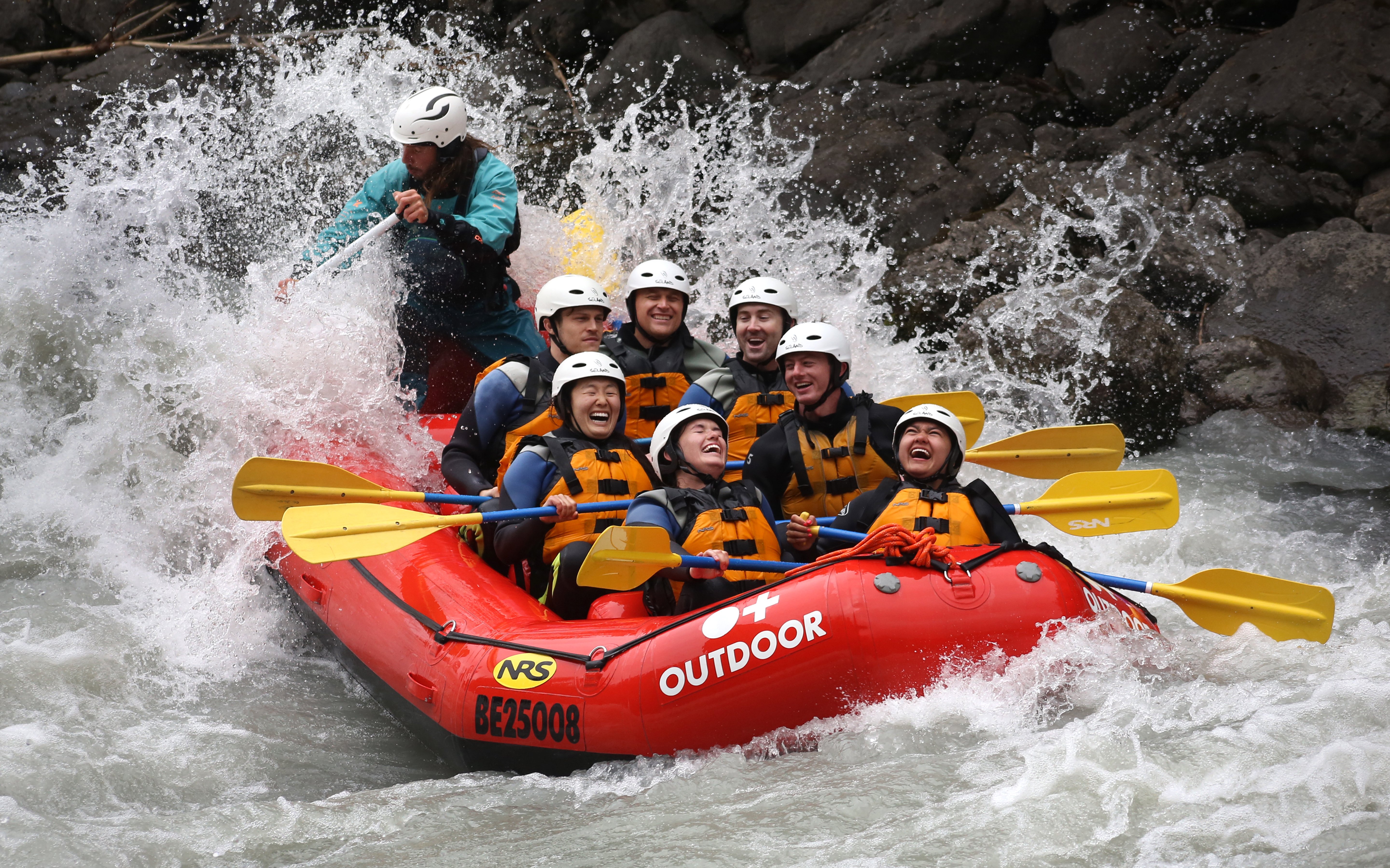 Rafting group navigating rapids on Lütschine River, Switzerland.