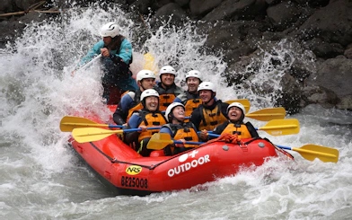 Rafting group navigating rapids on Lütschine River, Switzerland.