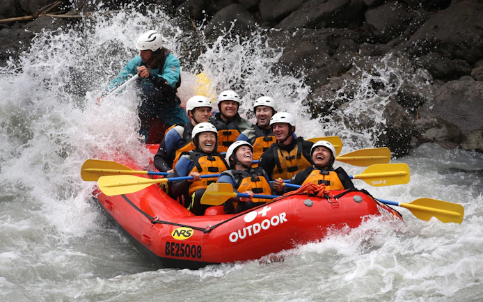 Rafting group navigating rapids on Lütschine River, Switzerland.