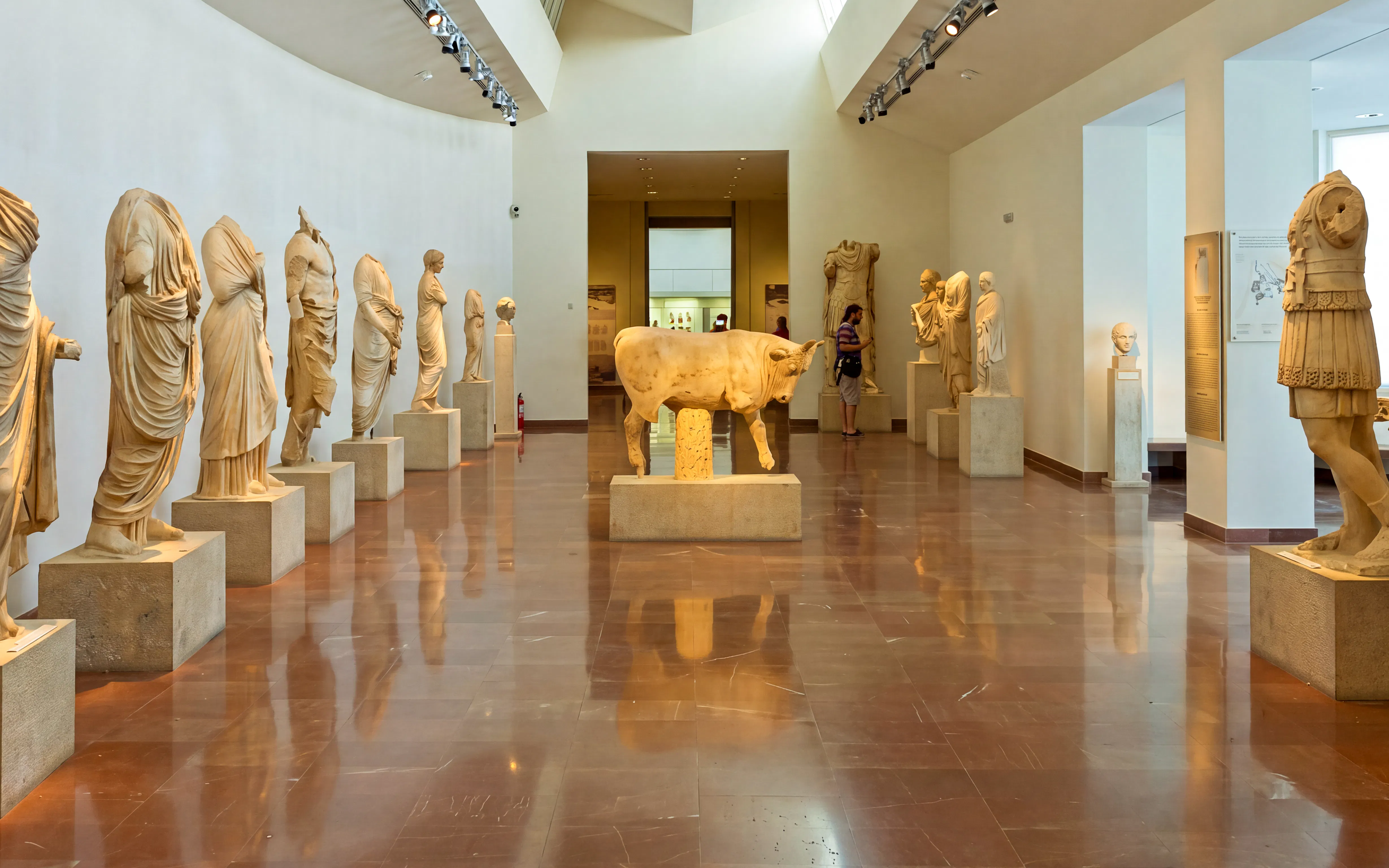 Statues in the Archaeological Museum of Olympia, featuring ancient Greek sculptures.