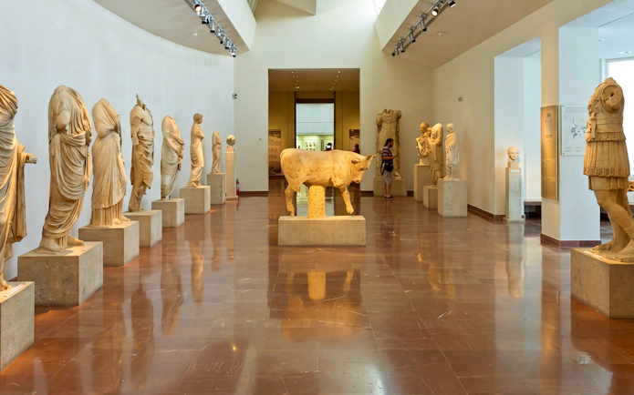 Statues in the Archaeological Museum of Olympia, featuring ancient Greek sculptures.